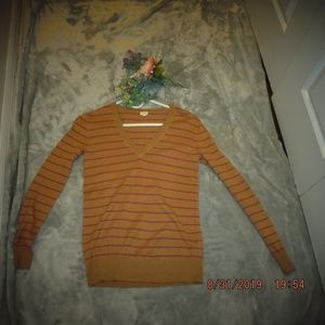 Tan and pink long-sleeved sweater.